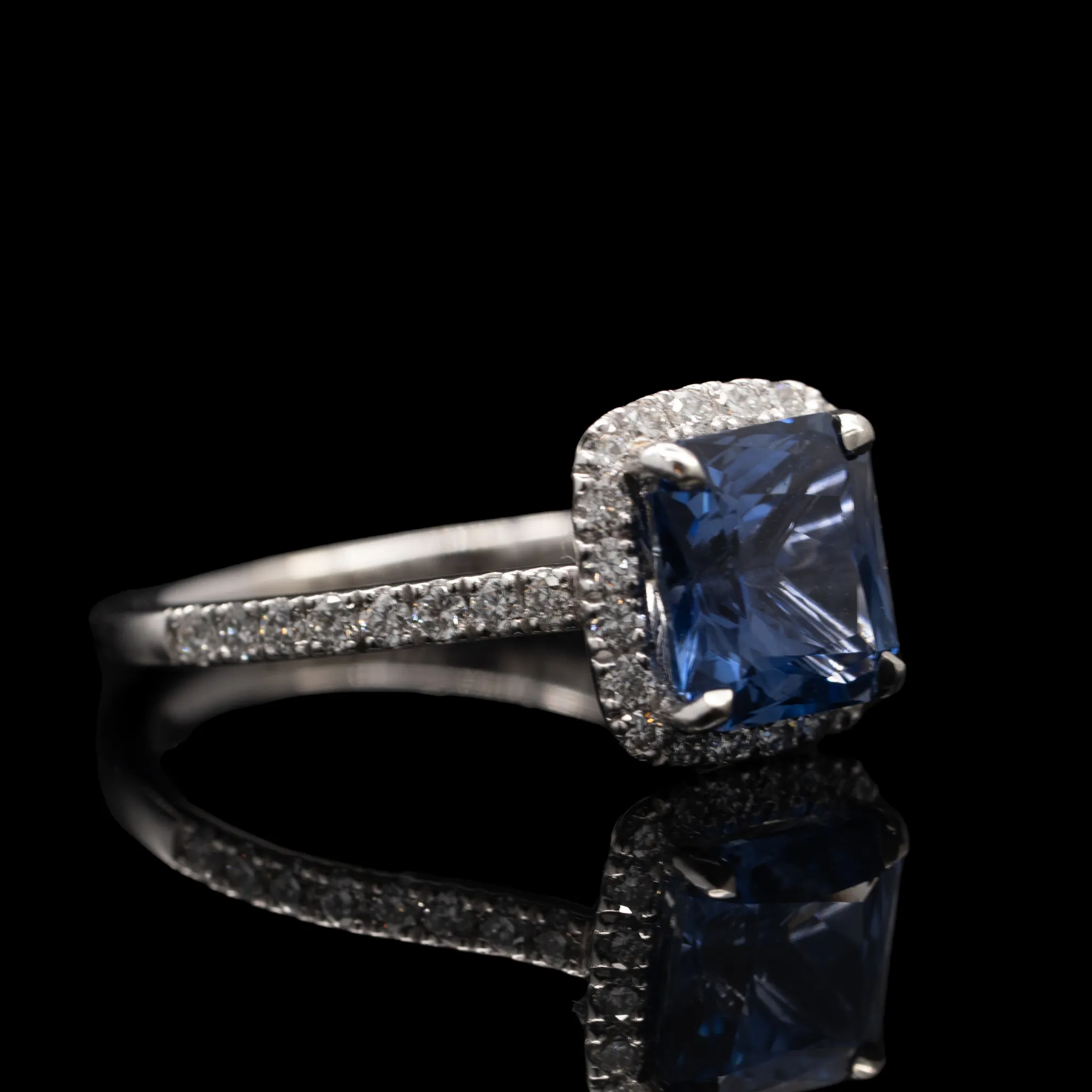 Blue Sapphire and Diamond Halo Engagement Ring