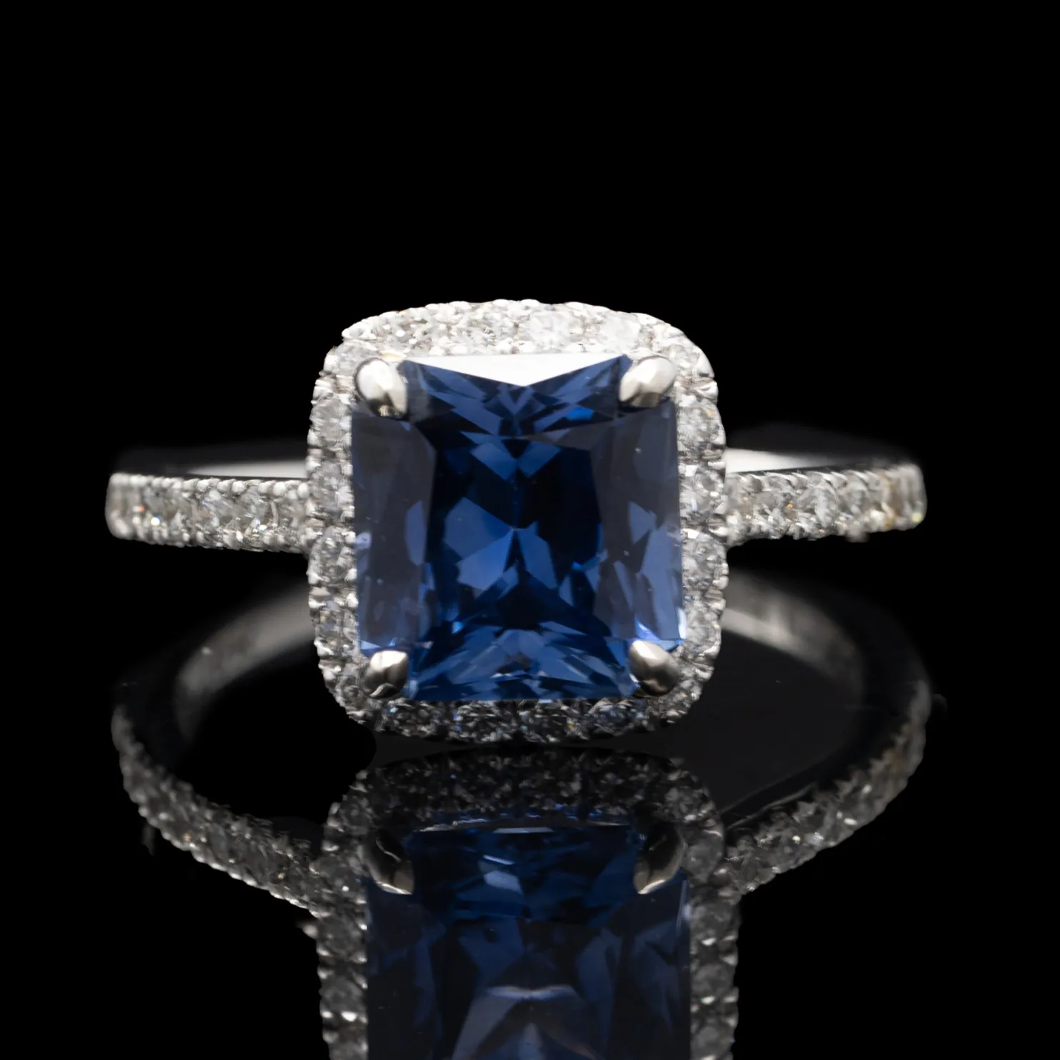 Blue Sapphire and Diamond Halo Engagement Ring